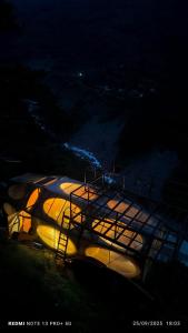 a group of boats sitting on a hill at night at Hotel cápsulas Mayta Capac in Sahuayacu