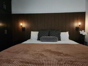 a bedroom with a large bed with two pillows at Modern Apartment in Rosarito