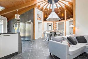 a living room with a couch and a kitchen at FY144-Middelfart-Vegavej-40 in Middelfart +13 photos