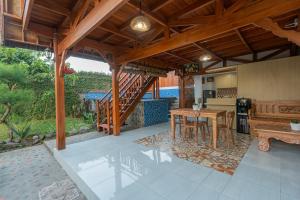an open kitchen and dining area of a house at Villa Darma Ubud by Bali Cabin in Ubud