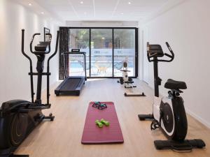 a gym with treadmills and exercise equipment in a room at Ibis Styles Cognac in Châteaubernard +104 photos