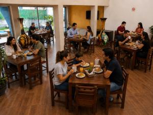 a group of people sitting at tables in a restaurant at Hotel Tepoztlán in Tepoztlán