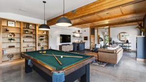 a living room with a pool table in it at Cascade Crest by AvantStay in Bend