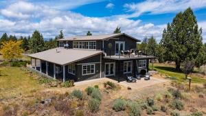 an aerial view of a black house with a roof at Cascade Crest by AvantStay in Bend