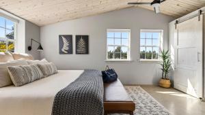 a bedroom with a large bed and windows at Cascade Crest by AvantStay in Bend