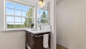 a bathroom with a sink and a window at Cascade Crest by AvantStay in Bend +48 photos