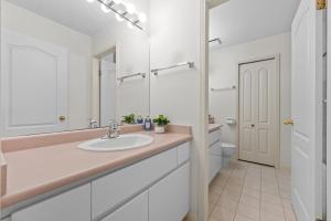 a bathroom with a sink and a toilet and a mirror at Home Base Quiet Queen Rooms in Richmond +30 photos