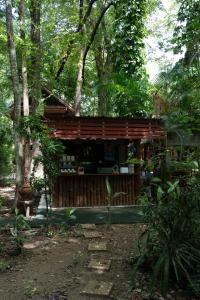 a small building in the middle of a forest at Akchanok Homestay - Nature Retreat in Phitsanulok