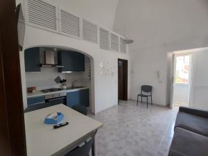 a kitchen and living room with a table and a couch at Casa Francesca Ponza in Ponza