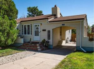 a small white house with an arch entrance at The sunflower stay in Garden City
