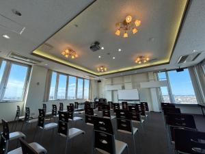 a room with chairs and a ceiling with windows at Lasting Hotel in Kushiro +158 photos