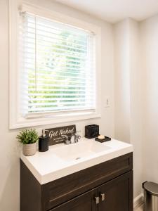a bathroom with a sink and a window at Stay by Gina in Irvington +10 photos