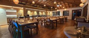 a restaurant with tables and chairs in a room at PSR Coral Resorts, 800m Away from Rameswaram Temple in Rāmeswaram