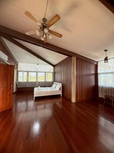 a living room with a couch and a ceiling fan at Bann Maii Soi 14 in Ban Hua Khao Sammuk +14 photos
