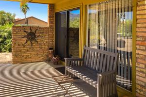 a porch with a bench on a house at Tranquil Trail #6 in Carefree