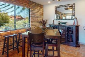 a dining room with a table and chairs and a mirror at Tranquil Trail #6 in Carefree +22 photos