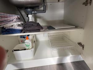 a kitchen cabinet with a sink and a sink at Flat Hills Tourist Park in Ruahine +108 photos