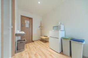 a small room with a refrigerator and a microwave at コインズホステル天神ペット宿泊可 in Fukuoka +47 photos