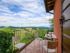 a balcony with chairs and a table with a view at Apartment in Sant'Angelo near Medieval Town in SantʼAngelo in Vado