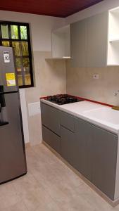 a kitchen with a stove and a refrigerator at Hotel Los alpes in Garagoa +1 photo