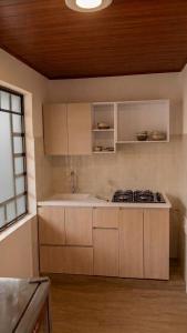 a kitchen with a sink and a stove in it at Hotel Los alpes in Garagoa