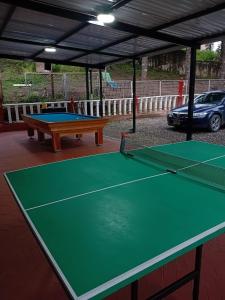 a ping pong table in a pavilion with a table tennis court at Hotel Los alpes in Garagoa