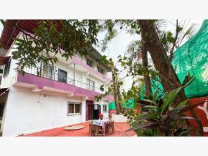 a building with a purple balcony and a table at The Grand Crest Residency in Panchgani