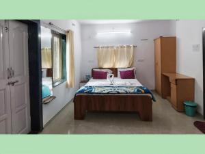 a small bedroom with a bed in a room at The Grand Crest Residency in Panchgani