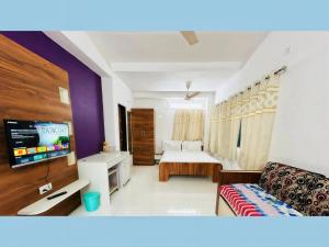 a living room with a bed and a couch at The Grand Crest Residency in Panchgani