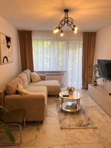 a living room with a couch and a table at Sara Apartament in Turek +37 photos