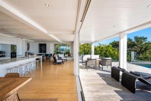 an open kitchen and living room of a house at No 63 - Stay Waiheke in Onetangi