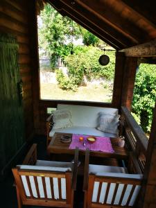 a table and chairs in a room with a window at Holiday Home Geppetto in Gornji Velemerić