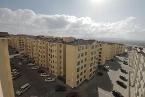an aerial view of a parking lot with buildings at Hidden Gems Homes Modern 2BR Near JKIA, Athi River in Athi River
