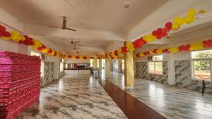 an empty room with colorful decorations on the walls at BRAHMANCHAL guest house in Barsāna