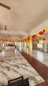 a large room with a dance floor with colorful decorations at BRAHMANCHAL guest house in Barsāna +1 photo