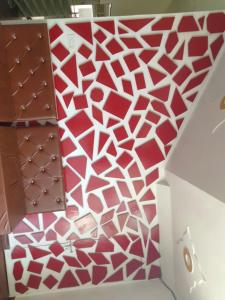 a staircase with a red and white patterned wall at BRAHMANCHAL guest house in Barsāna