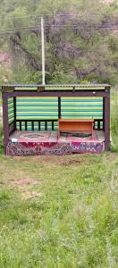 a bench sitting in the middle of a field at KochevniK in Almaty +7 photos