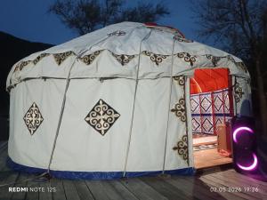 a large white tent with a red door at KochevniK in Almaty