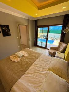 a bedroom with a large bed with a view of a pool at VİLLA Terasa in Fethiye +44 photos