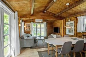 a dining room and living room with a table at 3032-Stege-Ankeret-4 in Stege