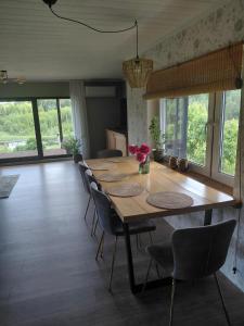 a dining room with a long wooden table and chairs at Tuule in Jeedasküla