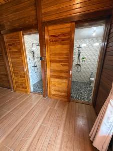 a room with two shower doors and a bathroom at Garuda Dive & Accomodation Nusa Penida in Nusa Penida