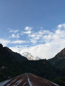 a view of a mountain range with snow capped mountains at Sunset Inn tosh in Tosh