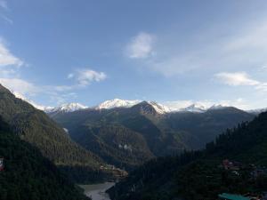 a view of a valley with snow capped mountains at Sunset Inn tosh in Tosh