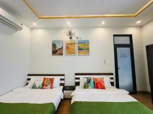 two beds sitting next to each other in a room at Arden Villa Quy Nhơn in Quy Nhon +79 photos