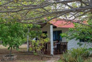 a woman sitting on the porch of a house at Payande - Tatacoa in Villavieja