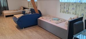 a room with a couch and a bed and a chair at Apartment Top 3 mit 4 Betten BESTROOMS eU in Steyr
