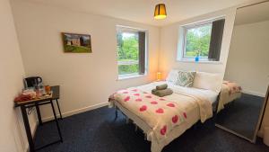 a bedroom with a bed with a teddy bear on it at Bambi Nest in Sketty