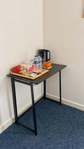 a black table with drinks and water bottles on it at Bambi Nest in Sketty