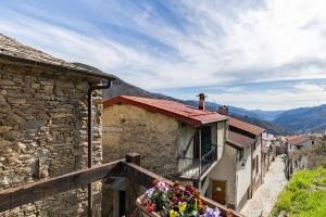 a balcony of a house with flowers on it at Rifugio Ca' da Cardella in Mendatica
